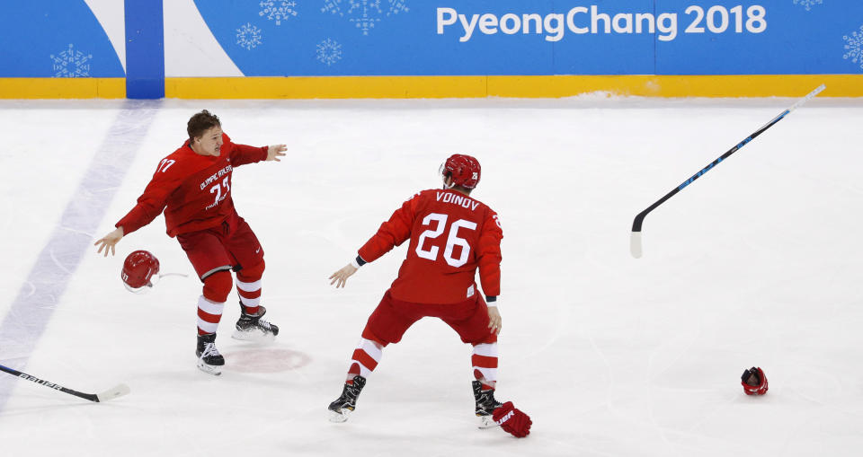 Russian athlete Kirill Kaprizov (77) and Vyacheslav Voynov (26) celebrate after winning the men’s gold medal hockey game against Germany, 4-3. (AP)