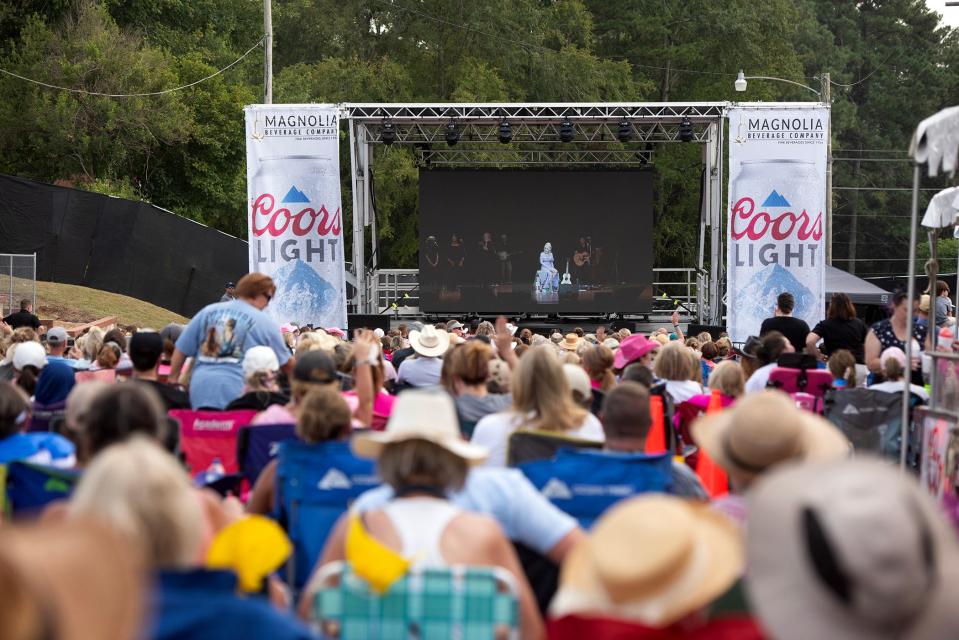 As Dolly Parton performs inside the Ellis Theater in Philadelphia. Miss., fans watch a live feed of the concert outside Saturday, Aug. 26, 2023.