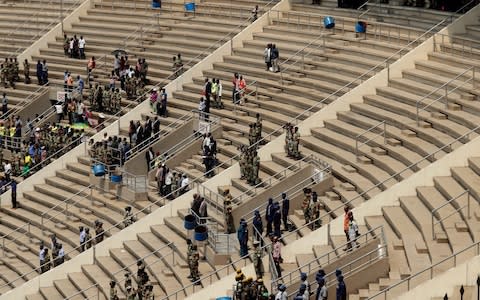 Large parts of the 60,000 seat stadium were empty during the ceremony  - Credit: Themba Hadebe/AP