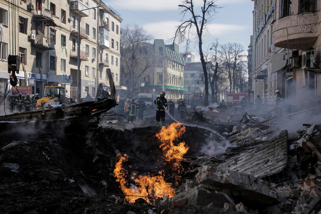 Firefighters extinguish an apartment house after a Russian rocket attack March 18 in Kharkiv, Ukraine's second-largest city.