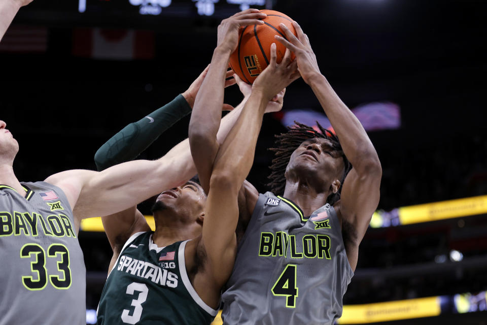 Baylor guard Ja'Kobe Walter, right, and Michigan State guard Jaden Akins (3) battle for a rebound during the second half of an NCAA college basketball game, Saturday, Dec. 16, 2023, in Detroit. Michigan State won 88-64. (AP Photo/Al Goldis)