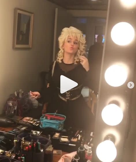 Miley Cyrus poses dressed as Dolly Parton