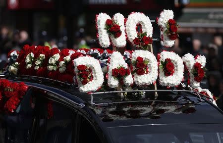 The coffin of PC Keith Palmer, who was killed in the recent Westminster attack, is driven away after his funeral in Southwark Cathedral in central London, Britain April 10, 2017. The flowers on the hearse spell out 'NO 1 DADDY.' REUTERS/Neil Hall