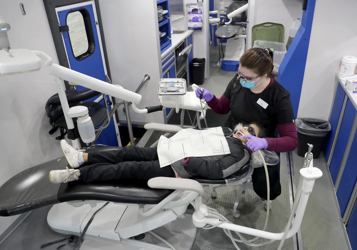 Hygienist Katie Wheeler cleans Sarahi Dominguez Rodriguez's teeth during a Tri-County Dental mobile clinic, part of the Robert Glass Focus on the Children program, on March 21, 2023, at Appleton Bilingual School in Appleton, Wis.