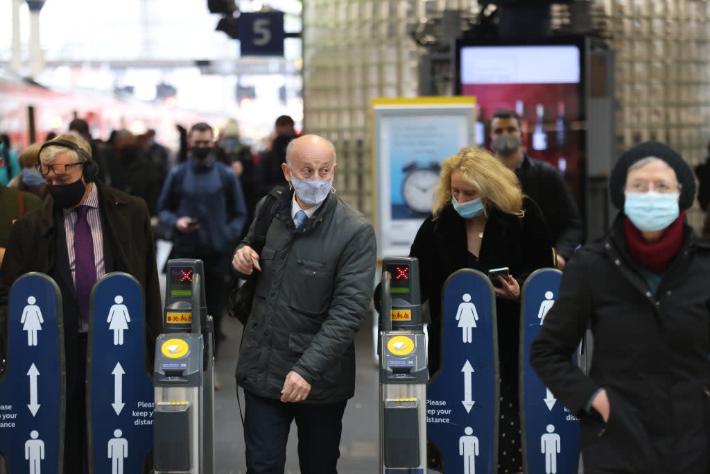 Passengers wearing masks travelling via Waterloo station in London (James Manning/PA) (PA Wire)