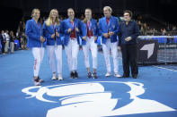 Switzerland's players Viktorija Golubic, Jil Teichmann, Belinda Bencic and Simona Waltert, Switzerland team captain Heinz Guenthardt and tennis legend Billie Jean King, from left, pose for photos after the Swiss defeated Australia to win the Billie Jean King Cup tennis finals, at the Emirates Arena in Glasgow, Scotland, Sunday, Nov. 13, 2022. (AP Photo/Kin Cheung)