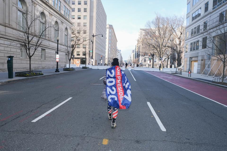 A lone Biden supporter wanders a normally bustling street in the Penn Quarter.