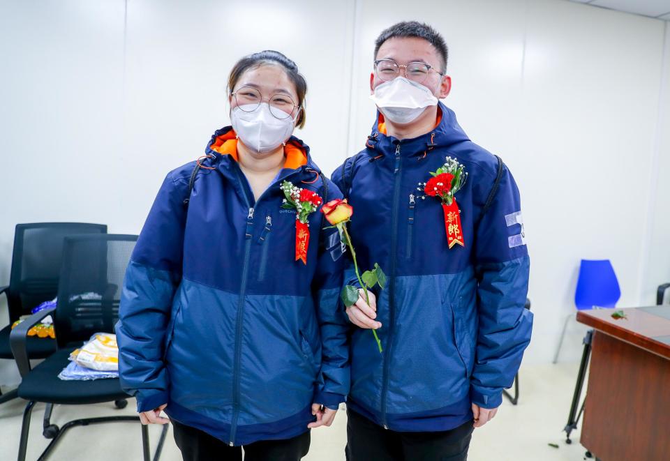 WUHAN, CHINA - FEBRUARY 28: 25-year-old bridegroom Yu Jinghai and 24-year-old bride Zhou Lingyi take part in their wedding ceremony at Leishenshan (Thunder God Mountain) makeshift hospital on February 28, 2020 in Wuhan, Hubei Province of China. Yu and Zhou are both nurses from Shanghai Renji Hospital. They have worked in Wuhan for 10 days and their wedding ceremony was scheduled to take place in Shanghai today. (Photo by Zhang Chang/China News Service via Getty Images)