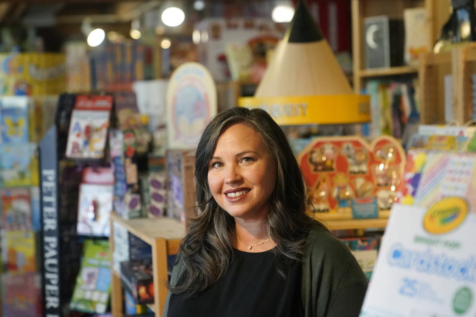 Stephanie Sala, owner of Five Little Monkeys, smiles while interviewed at her store in Berkeley, Calif., Monday, Dec. 12, 2022. Small retailers say this year looks much different than the last "normal" pre-pandemic holiday shopping season of 2019. They're facing decades-high inflation forcing them to raise prices and making shoppers rein in the freewheeling spending seen in 2021 when they were flush with pandemic aid and eager to spend. (AP Photo/Jeff Chiu)