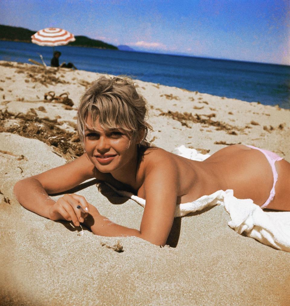 <p>Brigitte Bardot tans on the beach.</p>