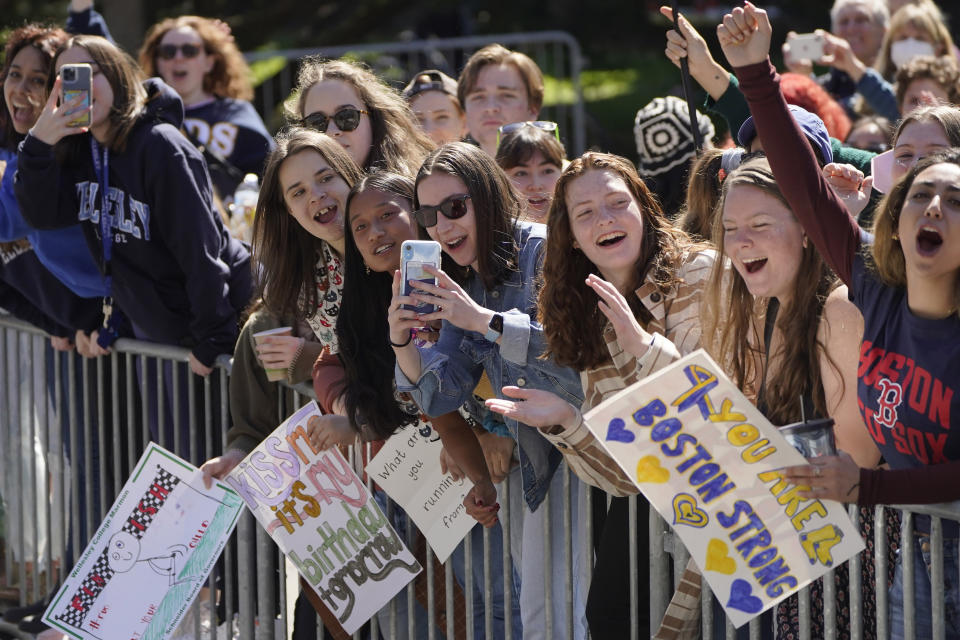 People cheer in front of Wellesley College, in Wellesley, Mass., as a runner passes during the 126th Boston Marathon, Monday, April 18, 2022. (AP Photo/Steven Senne)