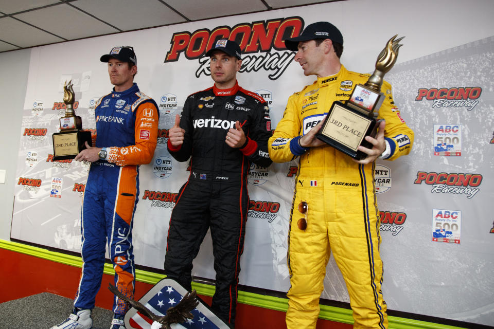 Will Power, center, poses after winning the IndyCar Series auto race at Pocono Raceway with second place finisher Scott Dixon, left, and third place finisher Simon Pagenaud, Sunday, Aug. 18, 2019, in Long Pond, Pa. (AP Photo/Matt Slocum)