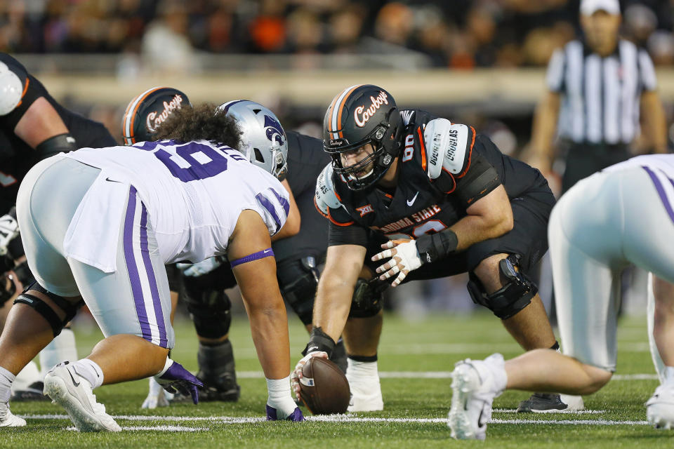 STILLWATER, OK - OCTOBER 6:  Center Joe Michalski #66 of the Oklahoma State Cowboys faces down defensive tackle Uso Seumalo #99 of the Kansas State Wildcats as he prepares to snap the ball in the first quarter at Boone Pickens Stadium on October 6, 2023 in Stillwater, Oklahoma.  Oklahoma State won 29-21.  (Photo by Brian Bahr/Getty Images)