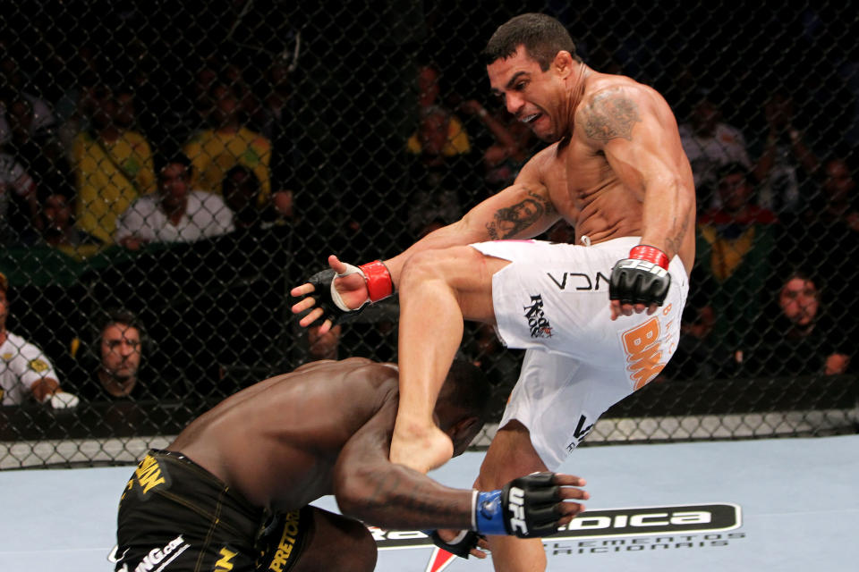 RIO DE JANEIRO, BRAZIL - JANUARY 14: Vitor Belfort (R) kicks Anthony Johnson (L) in a middleweight bout during UFC 142 at HSBC Arena on January 14, 2012 in Rio de Janeiro, Brazil. (Photo by Josh Hedges/Zuffa LLC/Zuffa LLC via Getty Images)