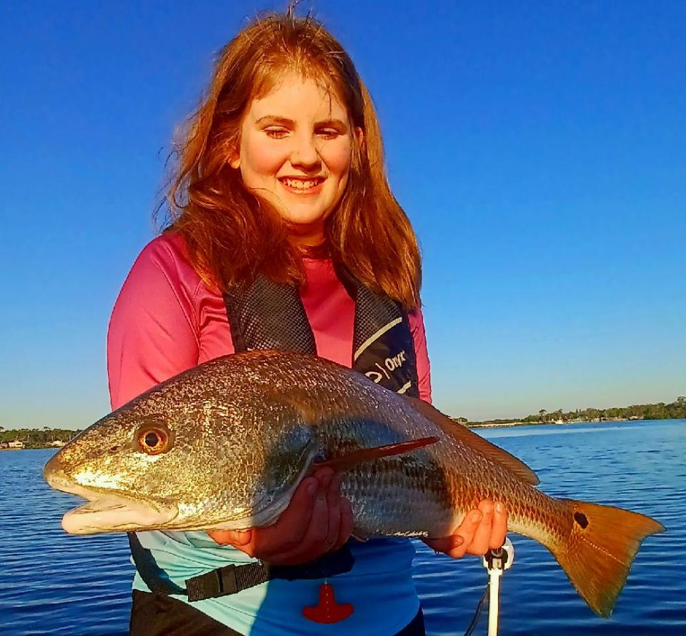 Hadleigh, on spring break from Indiana, checks in with this redfish, checking in at 7-plus pounds, caught aboard Capt. Billy Pettigrew's charter boat.