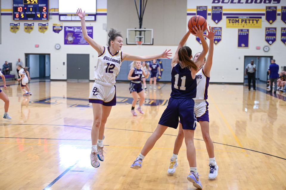 Bloom Carroll's Marissa Wilkinson and Emily Bratton attempt to stop Logan's Danika Mahaffey from passing the ball to a teammate down the court.