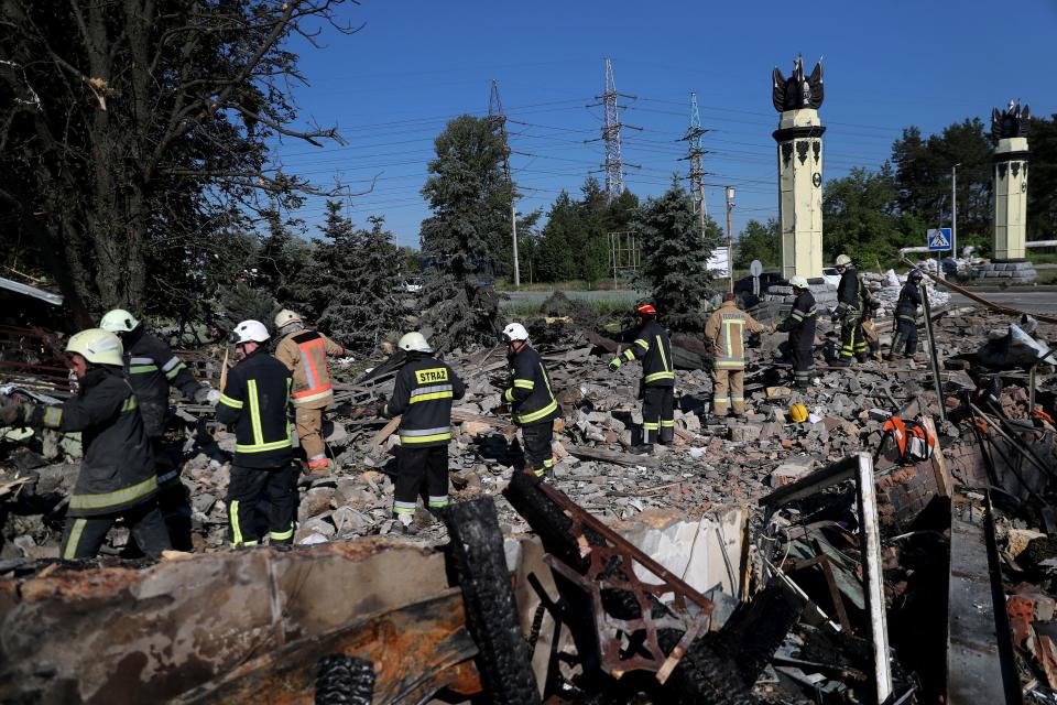 Firefighters remove debris searching a casualty following a military strike, as Russia's attack on Ukraine continues, in Kharkiv, Ukraine June 9, 2022. REUTERS/Ivan Alvarado