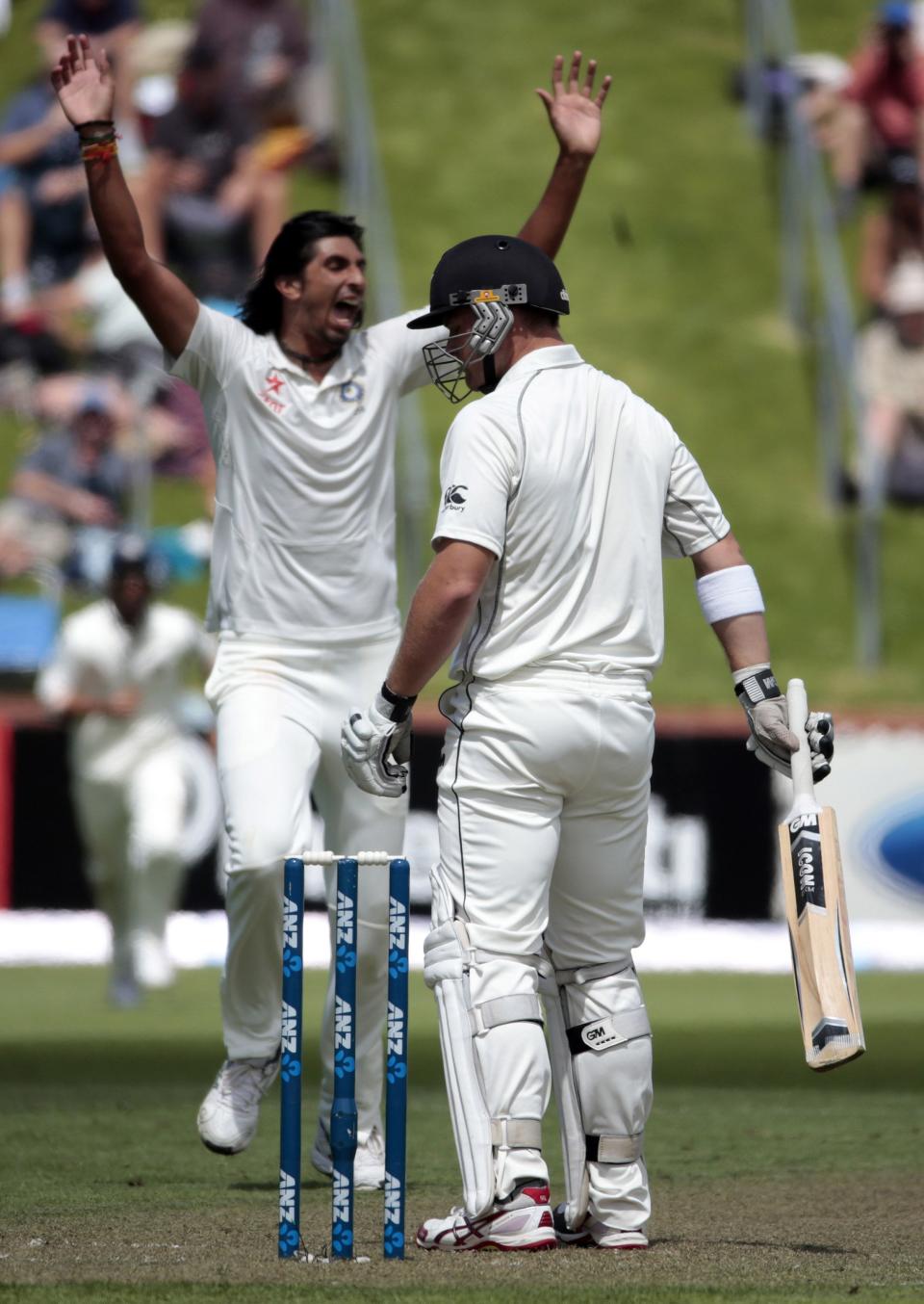 India's Ishant Sharma celebrates the dismissal of New Zealand's Corey Anderson (R) during day one of the second international test cricket match at the Basin Reserve in Wellington, February 14, 2014.