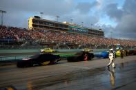 HOMESTEAD, FL - NOVEMBER 20: A crew member walks down pit road as rain falls during a red flag rain delay during the NASCAR Sprint Cup Series Ford 400 at Homestead-Miami Speedway on November 20, 2011 in Homestead, Florida. (Photo by Chris Graythen/Getty Images)