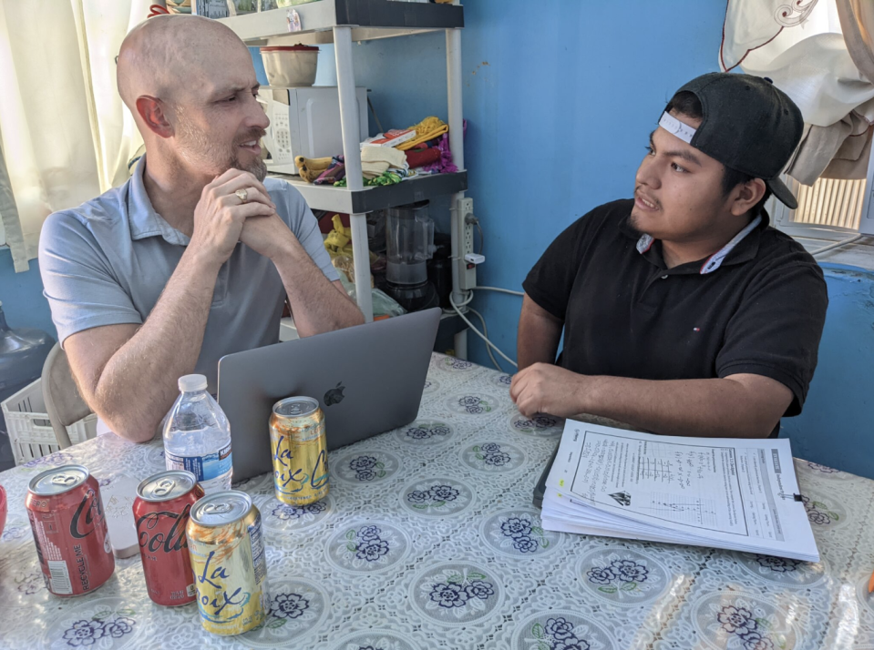 Rafael and his family friend, Seth Holmes, meet at the kitchen table of his home in Madera to send college applications and apply for special exemptions at universities across California.