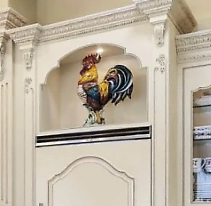 A close-up view of the kitchen shows a random rooster in the corner of the room used for decoration