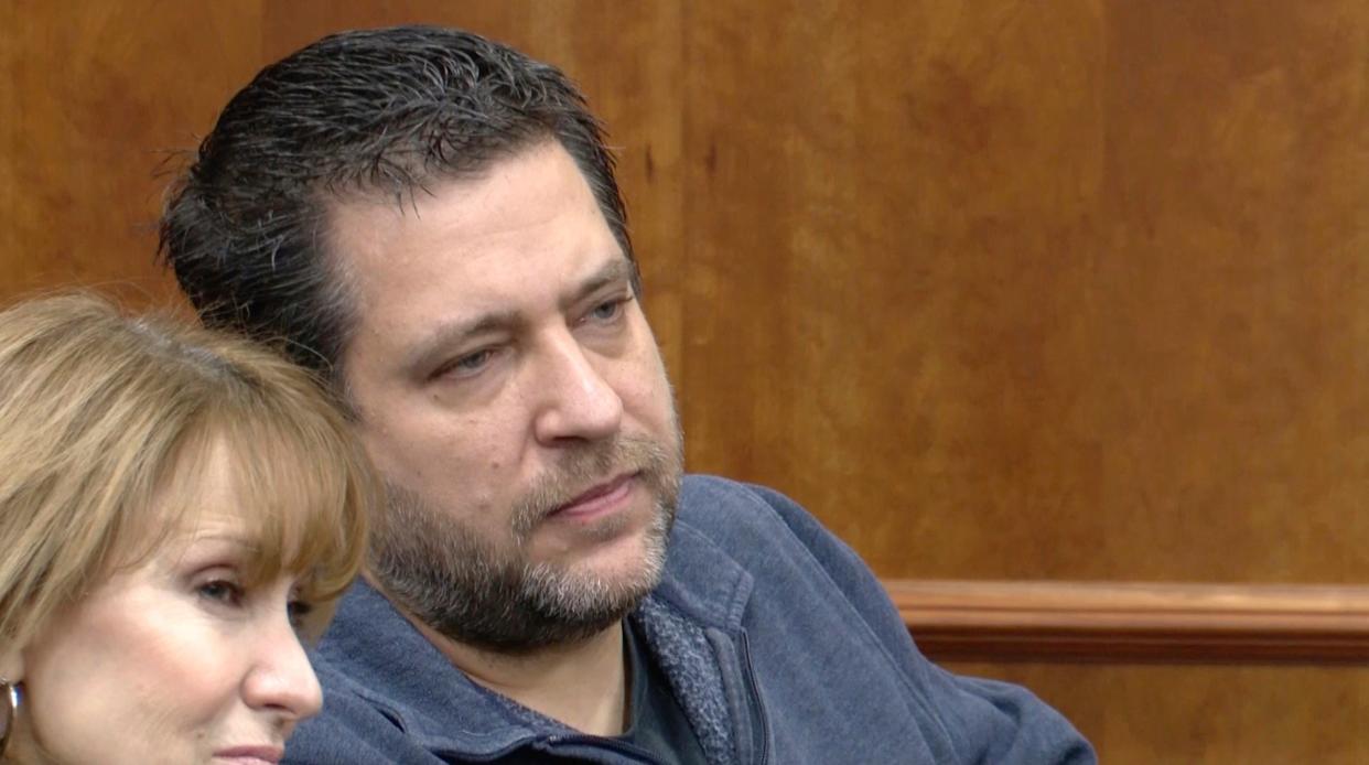 This image taken from video provided by WTVG shows Pastor of Dad's Place Chris Avell, right, sitting inside Bryan Municipal Court on Thursday, Jan. 11, 2024, in Bryan, Ohio. The Christian church filed a federal lawsuit Monday, Jan. 22, after being charged with violating the zoning laws in the northwestern Ohio city by opening up the church around-the-clock for homeless residents and others to find shelter.