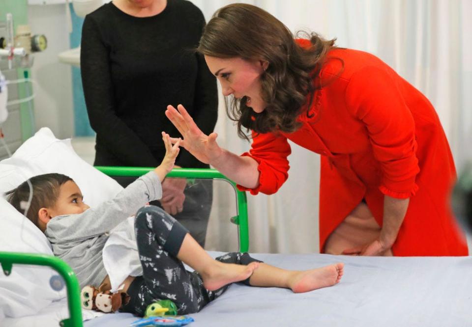 Kate Middleton high-fives a young hospital patient