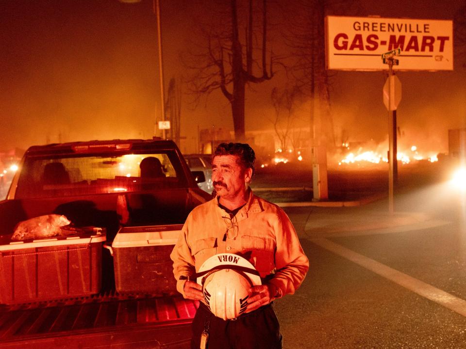 Battalion Chief Sergio Mora watches the destruction of the Dixie Fire through Greenville.