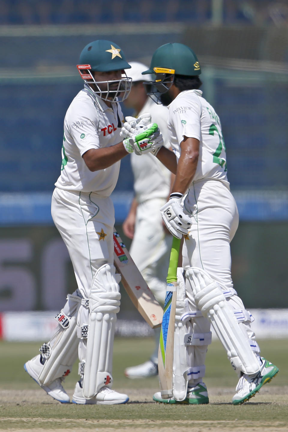 Pakistan's Babar Azam, left, is congratulated by Fawad Alam after completing 150 runs on the fifth day of the second test match between Pakistan and Australia at the National Stadium in Karachi Pakistan, Wednesday, March 16, 2022. (AP Photo/Anjum Naveed)