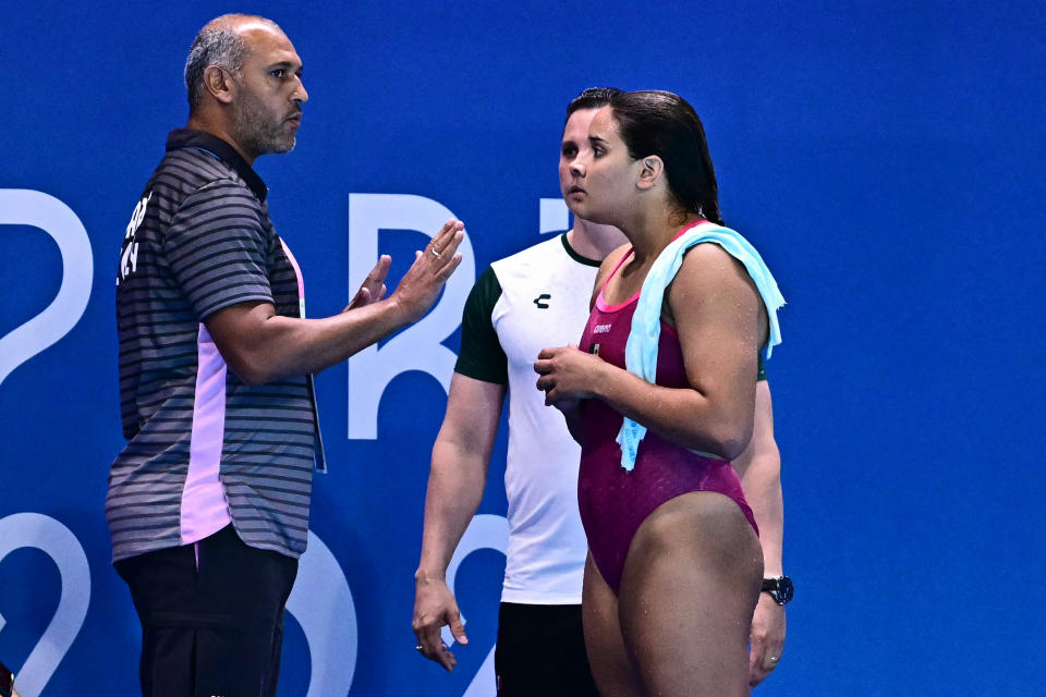 Mexico's Aranza Vazquez Montano (R) speaks to a judge in the women's 3m springboard diving semi-final during the Paris 2024 Olympic Games at the Aquatics Centre in Saint-Denis, north of Paris, on August 8, 2024. (Photo by Manan VATSYAYANA / AFP) (Photo by MANAN VATSYAYANA/AFP via Getty Images)