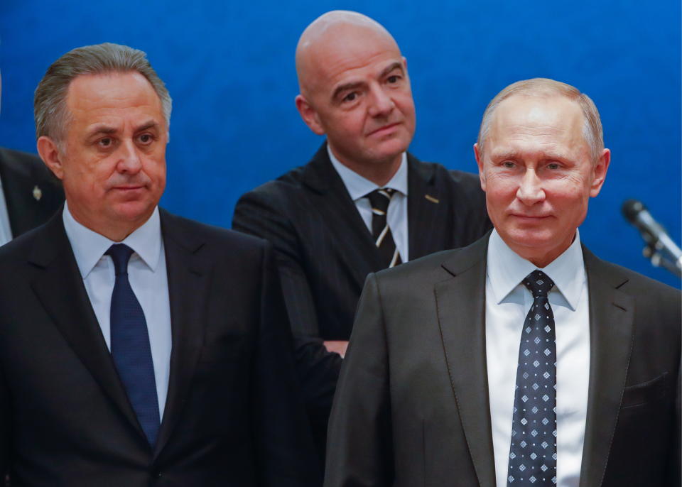 Vitaly Mutko (left) with FIFA president Gianni Infantino (center, back) and Russian president Vladimir Putin (right). (Getty)