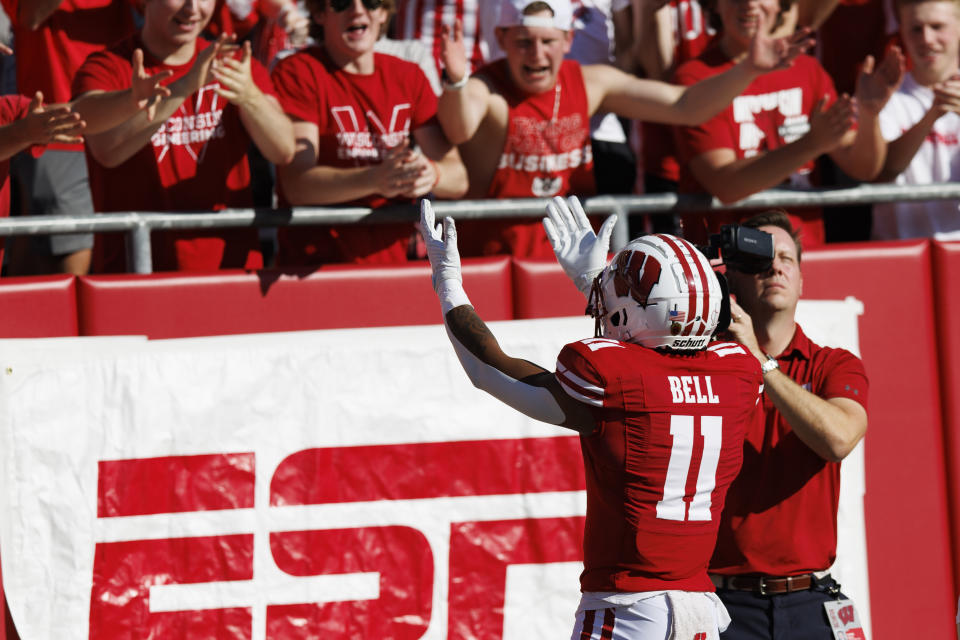 Oct 22, 2022; Madison, Wisconsin, USA; Wisconsin Badgers wide receiver Skyler Bell (11) celebrates after scoring a touchdown during the first quarter against the Purdue Boilermakers at Camp Randall Stadium. Mandatory Credit: Jeff Hanisch-USA TODAY Sports
