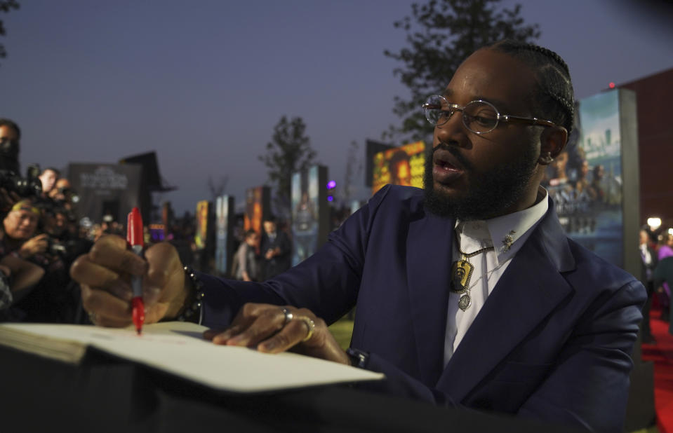 Director Ryan Coogler signs autographs on the red carpet at the premiere of Black Panther: Wakanda Forever, in Naucalpan, Mexico state, Mexico, Wednesday, Nov. 9, 2022. (AP Photo/Marco Ugarte)