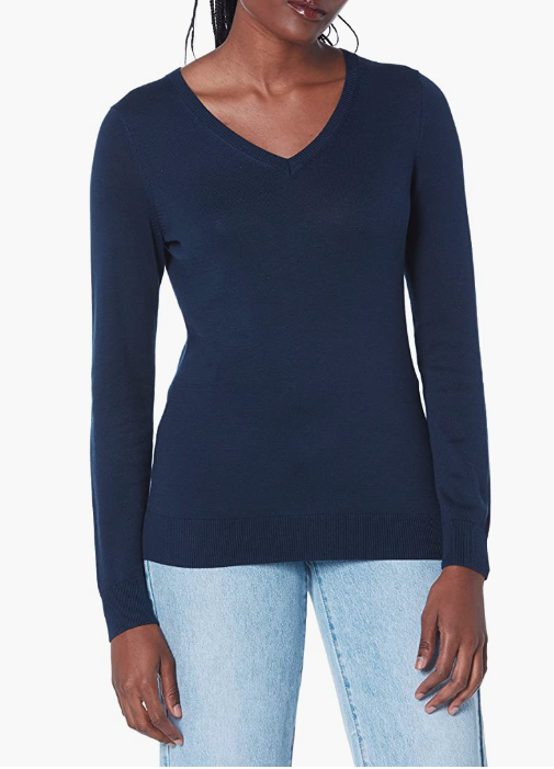 black woman with braids wears Amazon Essentials Womens Lightweight V-Neck Sweater in navy and blue jeans