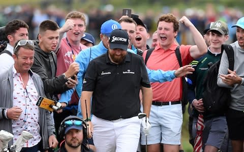 Shane Lowry of Ireland and spectators surrounding him react after his second shot on the 14th hole during the third round of the 148th Open Championship held on the Dunluce Links at Royal Portrush Golf Club - Credit: Getty images