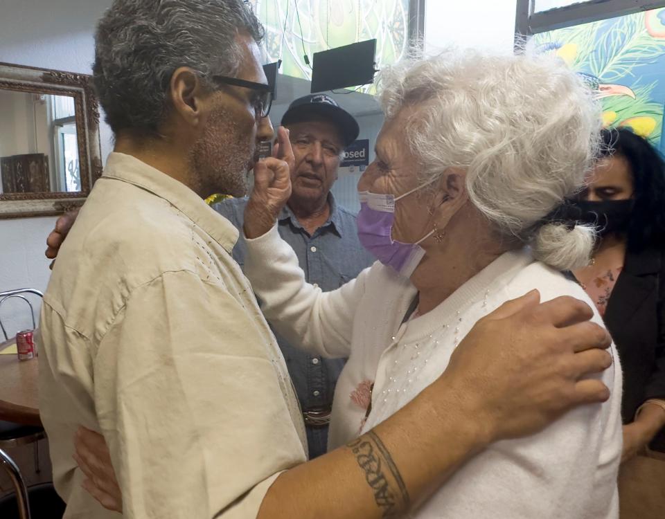 Chef David Raigoza gets a blessing from his mother, Maria Raigoza of Oxnard, when she and other family members visit his Santa Paula restaurant and catering service on Wednesday.