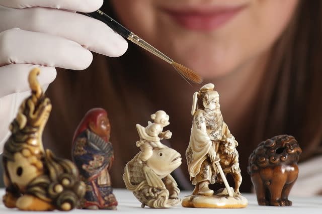 Assistant Conservator Margot Murray working on carved ivory netsuke figurines from late 18th-early 19th century Japan