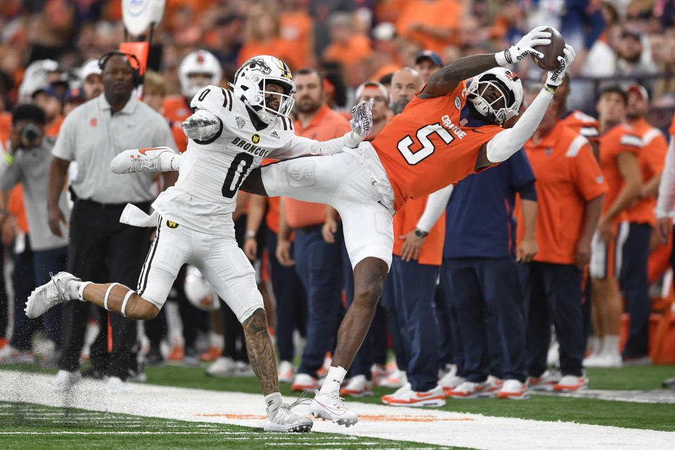 Syracuse wide receiver Damien Alford (5) reaches for the ball in front of Western Michigan cornerback DaShon Bussell (0) during the first half of an NCAA college football game in Syracuse, N.Y., Saturday, Sept. 9, 2023. (AP Photo/Adrian Kraus)