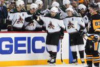 Arizona Coyotes' Nick Schmaltz (8) returns to the bench after scoring during the second period of an NHL hockey game against the Pittsburgh Penguins in Pittsburgh, Tuesday, Jan. 25, 2022. (AP Photo/Gene J. Puskar)