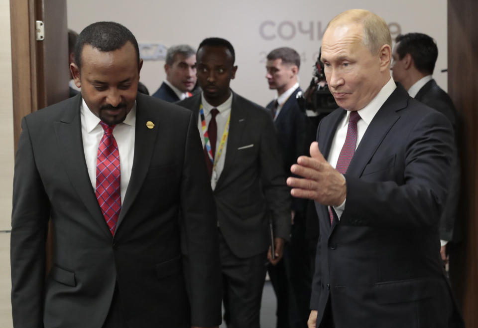 Russian President Vladimir Putin, right, welcomes Ethiopian Prime Minister Abiy Ahmed for the talks on the sideline of Russia-Africa summit in the Black Sea resort of Sochi, Russia, Wednesday, Oct. 23, 2019. (AP Photo/Sergei Chirikov, pool photo via AP)