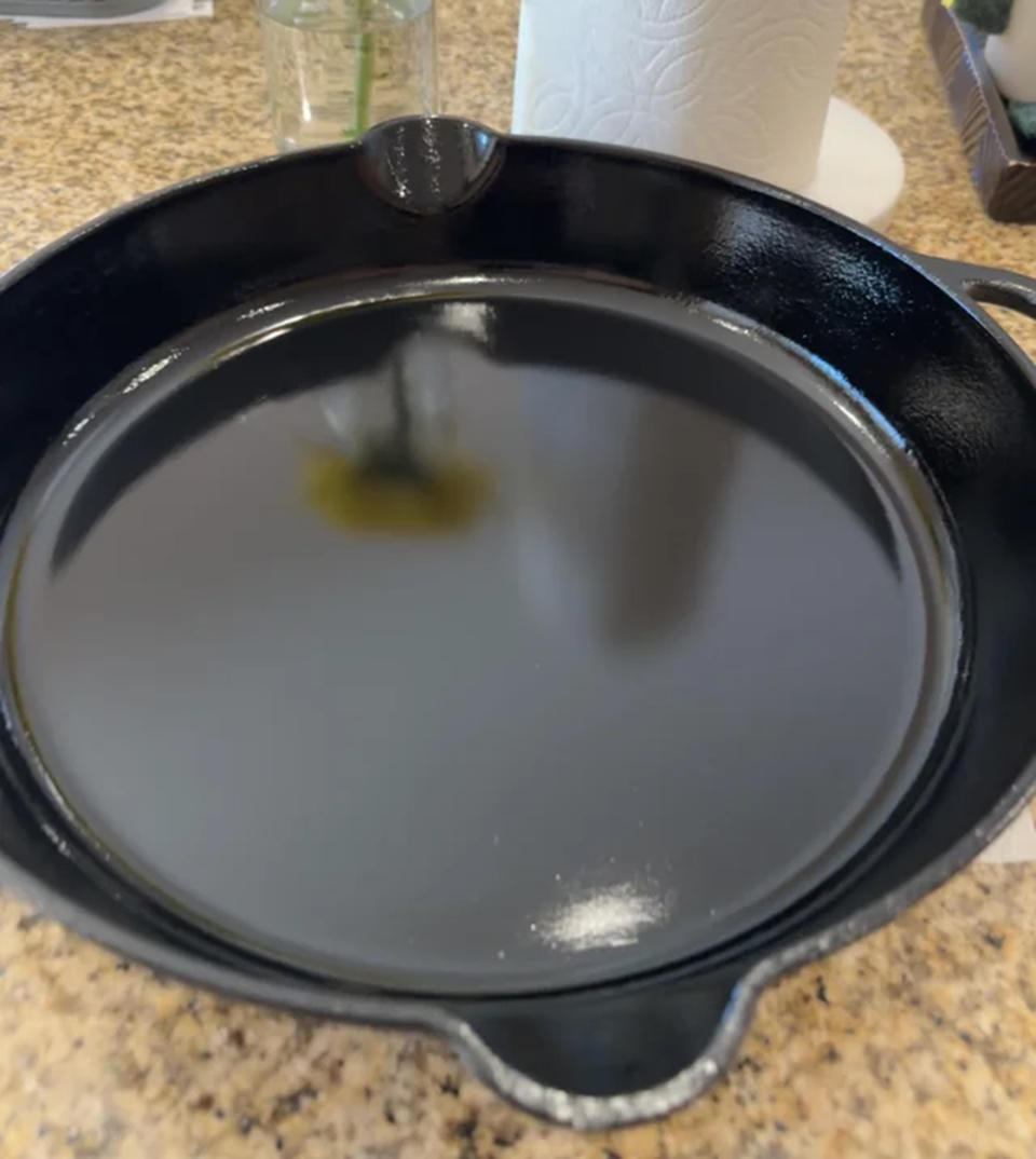 Dewey's cast-iron skillet with 80 coats of seasoning with a flower in the reflection. (Courtesy u/fatmummy222 via Reddit)
