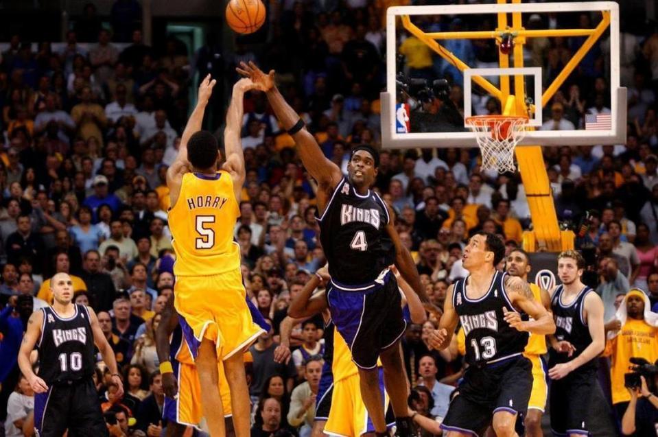 With less than one second remaining on the clock, Robert Horry shoots a three-point shot over the reach of Chris Webber In Game 4 of the NBA Western Conference Finals between the Sacramento Kings and the Los Angeles Lakers at Staples Center on May 26, 2002.