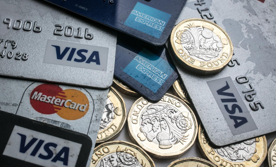 BRISTOL, ENGLAND - NOVEMBER 03:  In this photo illustration credit and debit cards are seen alongside pound coins on November 3, 2017 in Bristol, England. The Bank of England raised interest rates from a historic low for the first time in ten years this week raising costs of lending and concerns for householder debt.  (Photo by Matt Cardy/Getty Images)