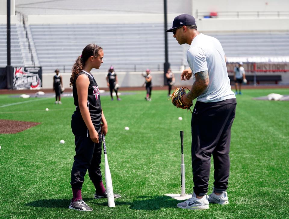 New York Yankees shortstop Gleyber Torres coaches Paterson Divas player Leahnie Ramos, 10, during a skills clinic in celebration of "Hope week" at Hinchliffe Stadium on Wednesday, July 5, 2023, in Paterson.