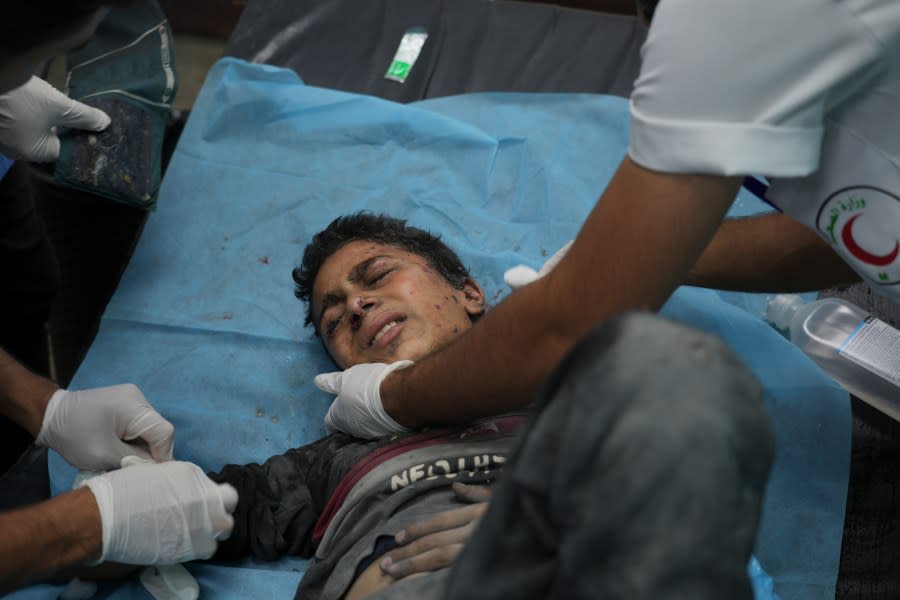 Palestinian kid wounded in Israeli bombardment is treated in a hospital in Deir al-Balah, south of the Gaza Strip, Friday, Oct. 20, 2023. (AP Photo/Hatem Moussa)
