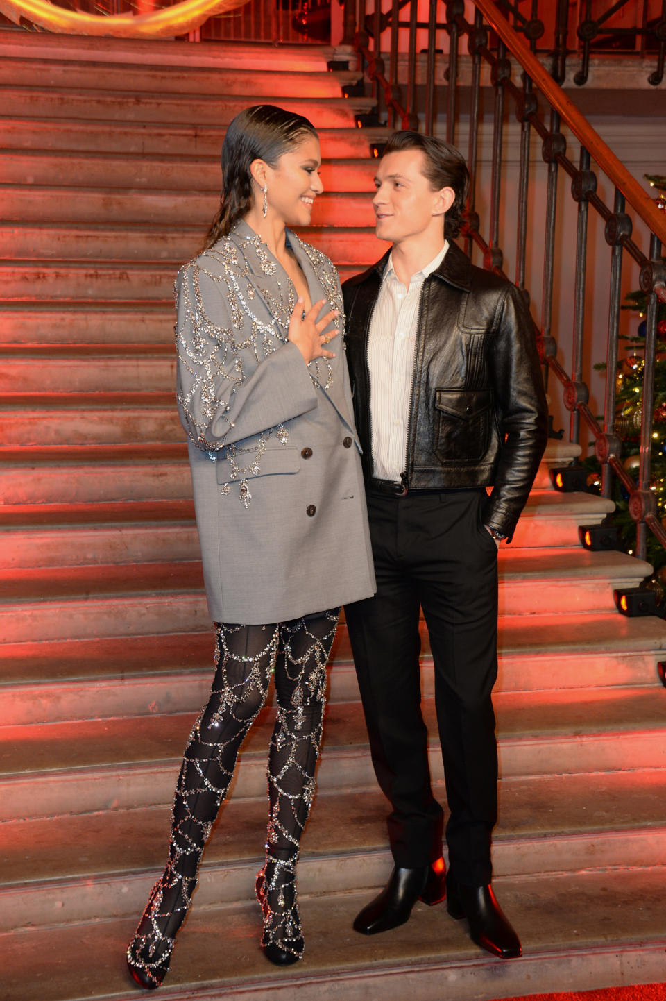 The couple smiling at each other at the premiere