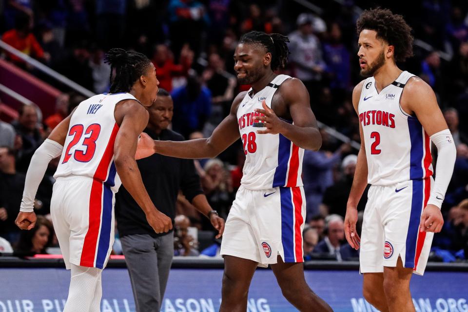 Detroit Pistons guard Jaden Ivey, center Isaiah Stewart and guard Cade Cunningham celebrate a basket vs. the Orlando Magic during the second half of the season opener at Little Caesars Arena in Detroit on Oct. 19, 2022.