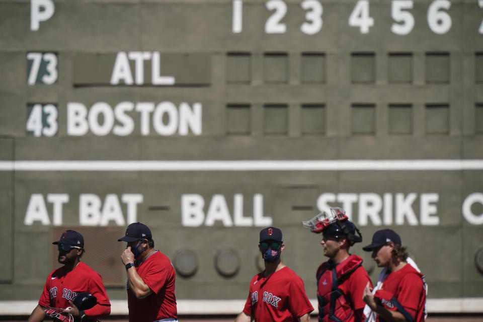 The Boston Red Sox's players walk on the field before a spring training baseball game against the Atlanta Braves on Monday, March 1, 2021, in Fort Myers, Fla. (AP Photo/Brynn Anderson)