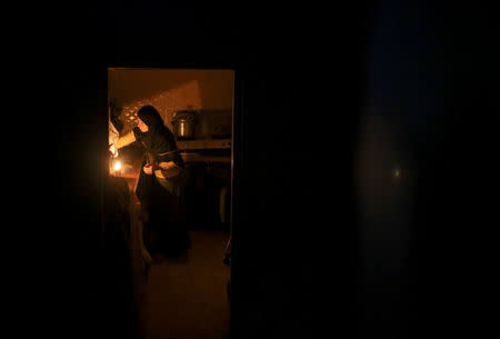 A Palestinian woman washes up in her kitchen during power cut at Shati refugee camp in Gaza City April 25, 2017. REUTERS/Mohammed Salem