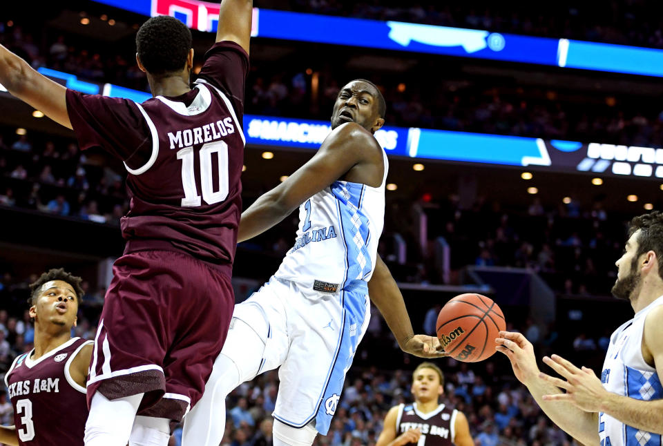 Mar 18, 2018; Charlotte, NC, USA; North Carolina Tar Heels guard Joel Berry II (2) passes the ball behind his back to forward <a class="link " href="https://sports.yahoo.com/nba/players/6272/" data-i13n="sec:content-canvas;subsec:anchor_text;elm:context_link" data-ylk="slk:Luke Maye;sec:content-canvas;subsec:anchor_text;elm:context_link;itc:0">Luke Maye</a> (32) against Texas A&M Aggies center Tonny Trocha-Morelos (10) during the first half in the second round of the 2018 NCAA Tournament at Spectrum Center. Mandatory Credit: Bob Donnan-USA TODAY Sports